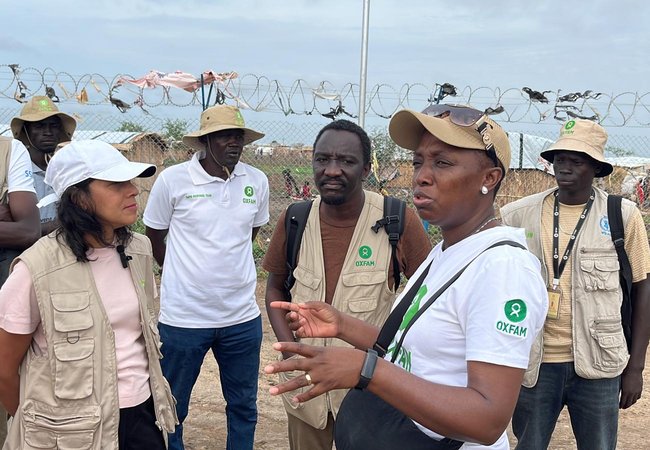 Halima Begum in Sudan talking with Oxfam partners